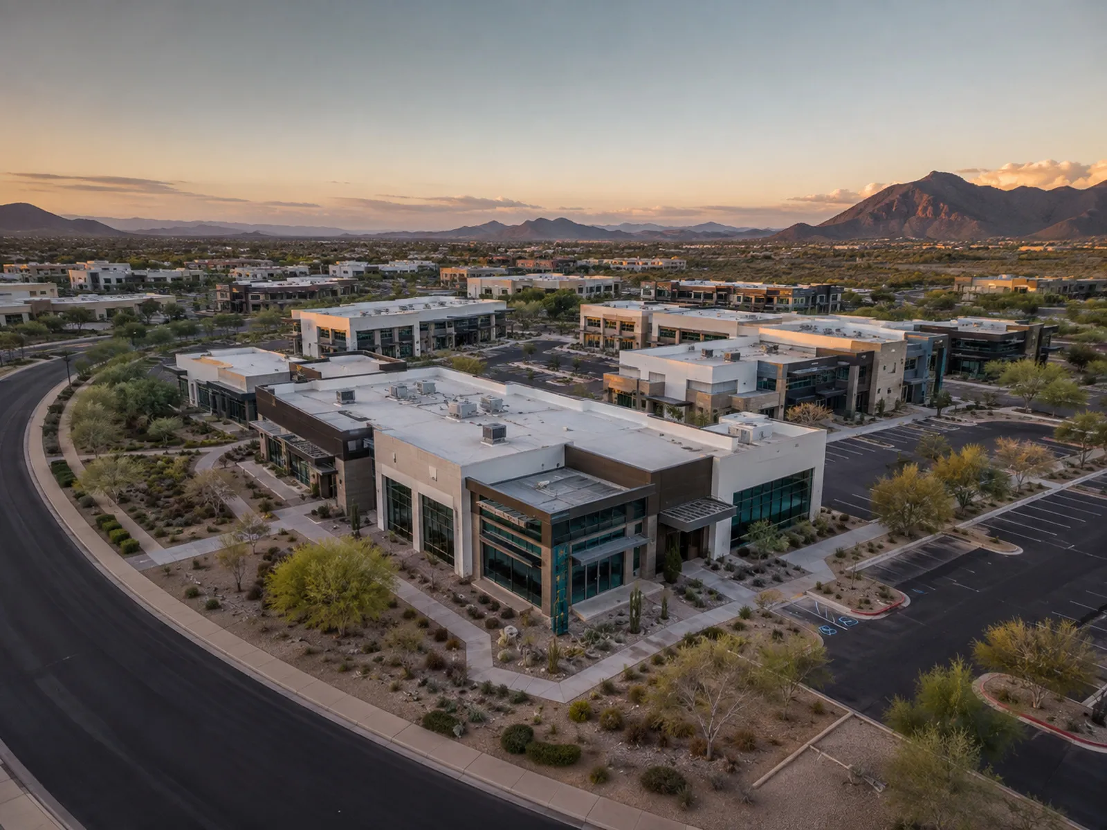 Polished aerial view of a commercial development; asset-focused composition.